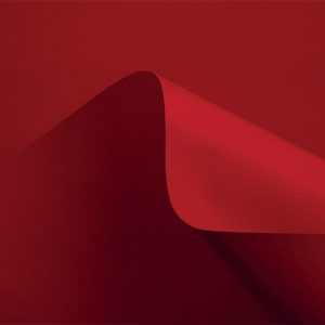 Curious Matter Desiree Red cardstock featuring an intensely saturated crimson red hue and a signature microscopic sand texture.